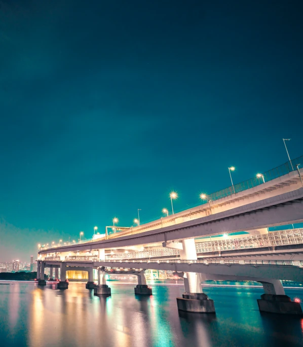 a train on a bridge over some water