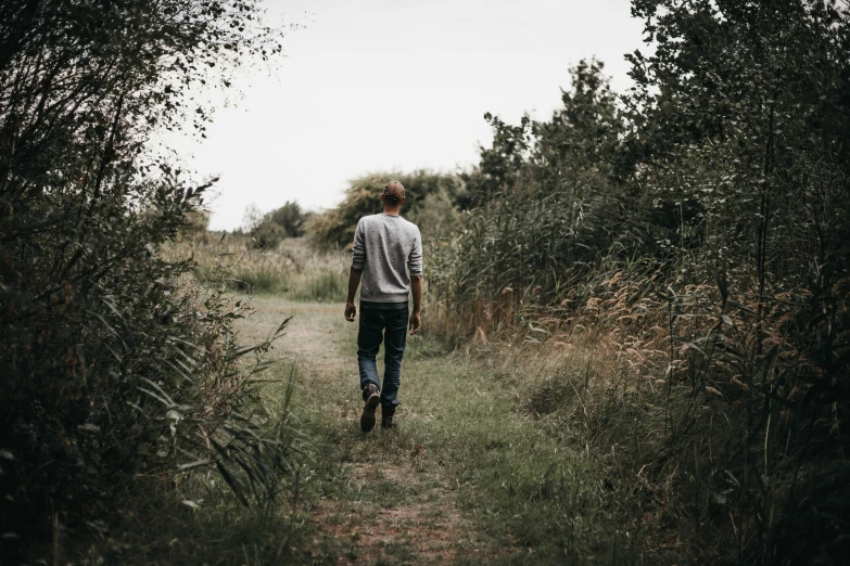 a person walking through some trees on a path