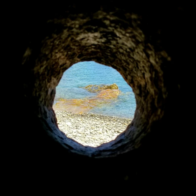 a picture taken through a hole in the rocks