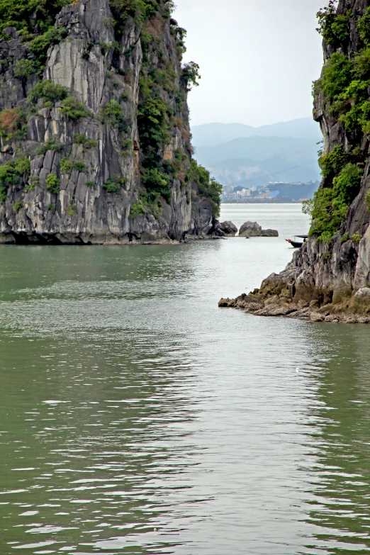 a boat that is in the water by some rocks