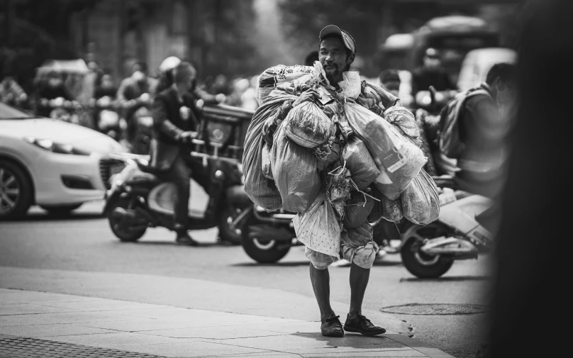 a man wearing a big sack of food standing on the street