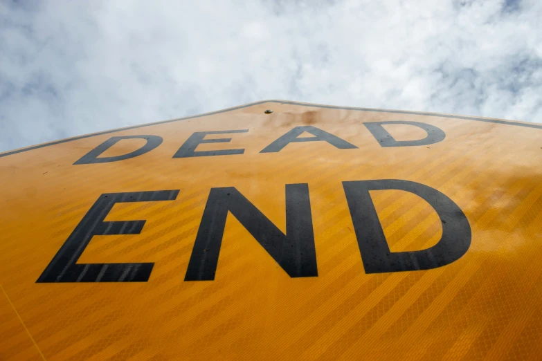 the side of a road sign reads dead end