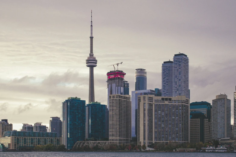 a view of some very tall buildings near the water