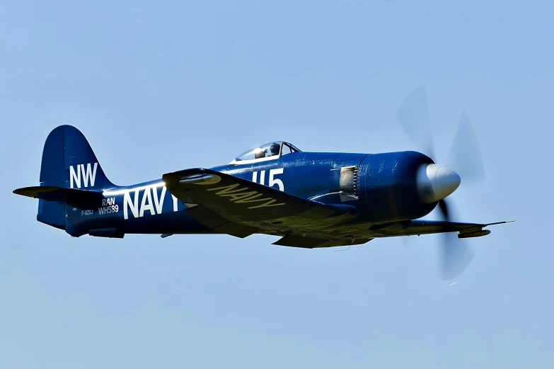 a blue jet flying through a blue sky