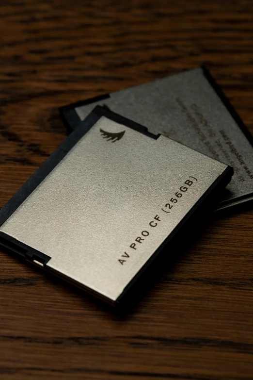 two card holders sitting next to each other on a wooden table