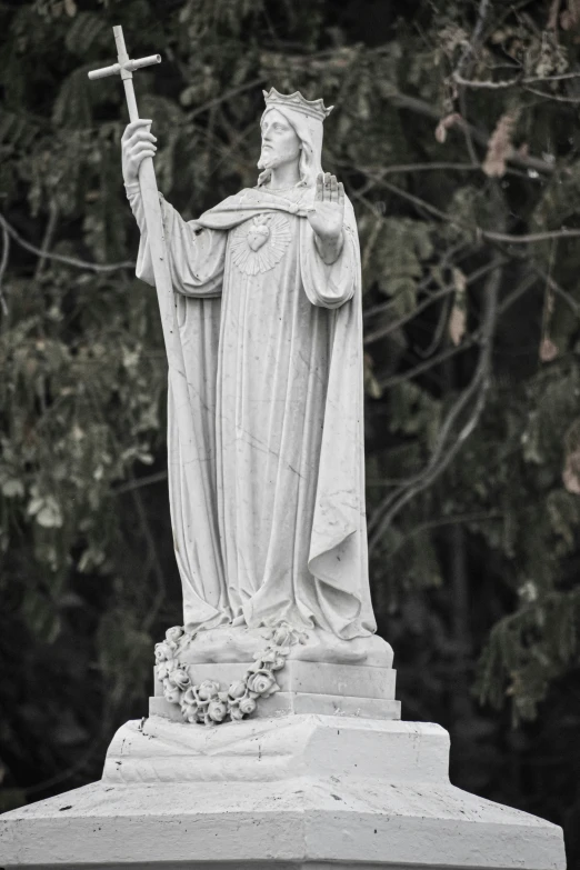 statue with the cross on it of jesus