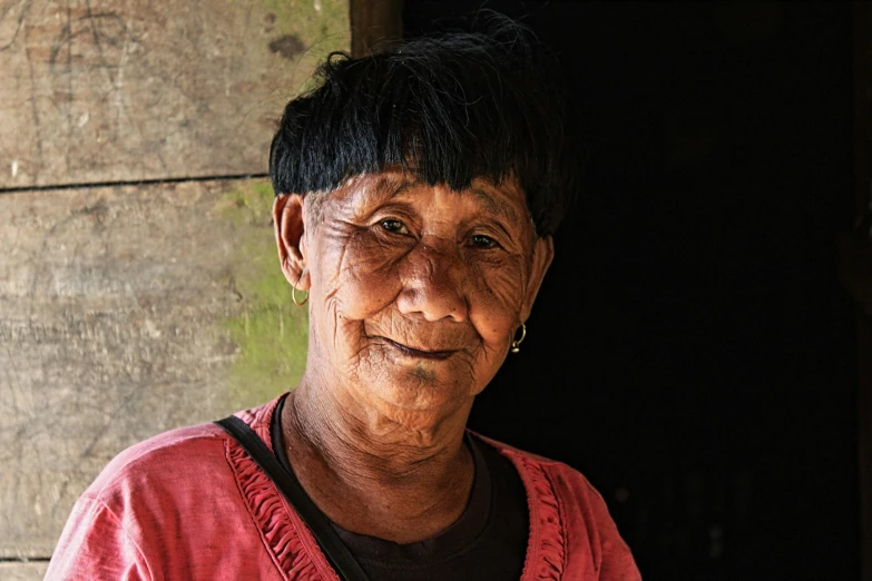 an old woman smiling on the street in a small town