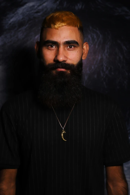 a man with a long beard wearing a necklace