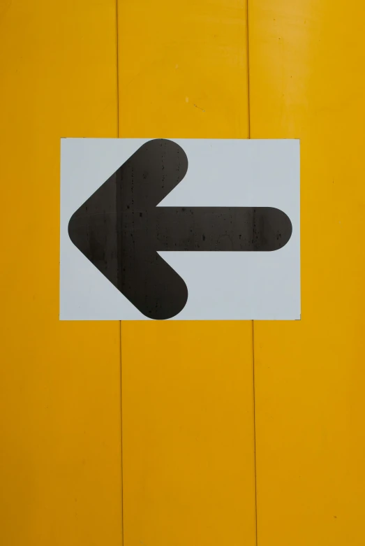 a close up of a sign with a arrow on it