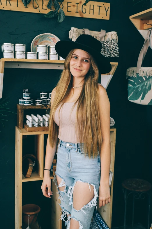 a pretty young lady in a cowboy hat posing for a po