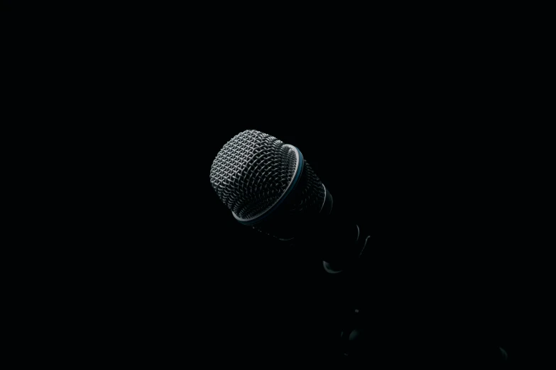 a close up of a microphone with dark lighting