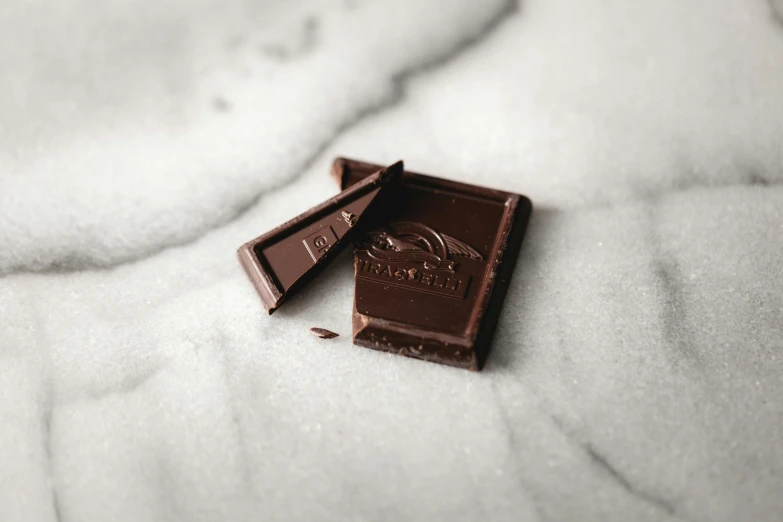 a bar of chocolate partially opened on top of a blanket