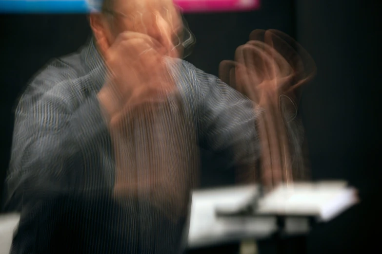 blurry po of man at desk with remote control