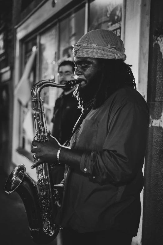 a man that is standing up with a saxophone