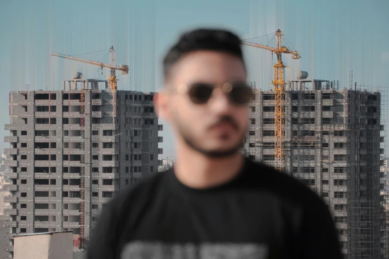 a man standing in front of buildings under construction