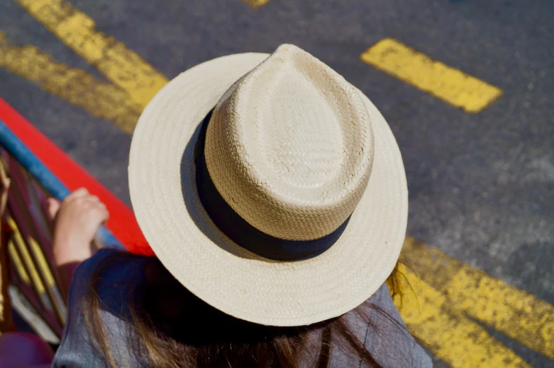 a woman's hat is seen sitting on the bench