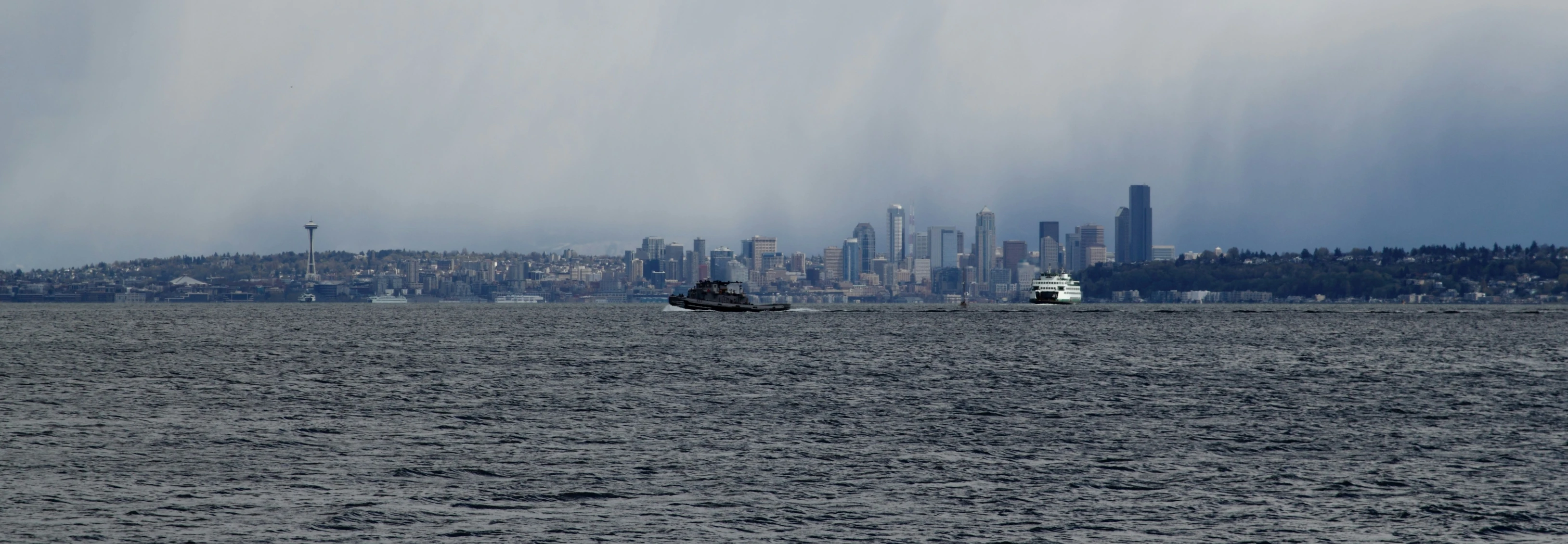 an image of a boat in the water near a large city