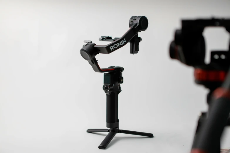 a camera attached to a tripod on a white background