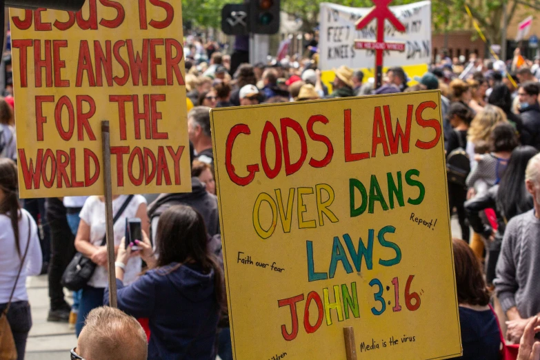 people holding signs reading god's law