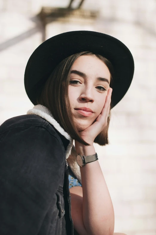 a girl with a hat poses for the camera