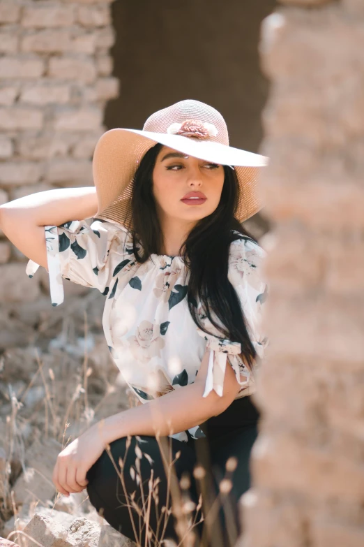 a woman with black hair wearing a white hat