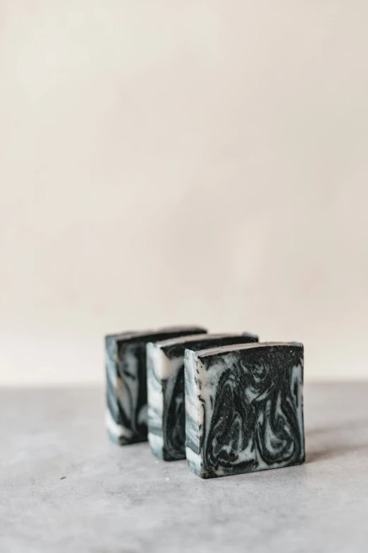 a small pair of black and white soap blocks on a table