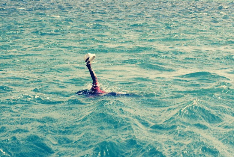 a person swimming in the ocean alone on the back