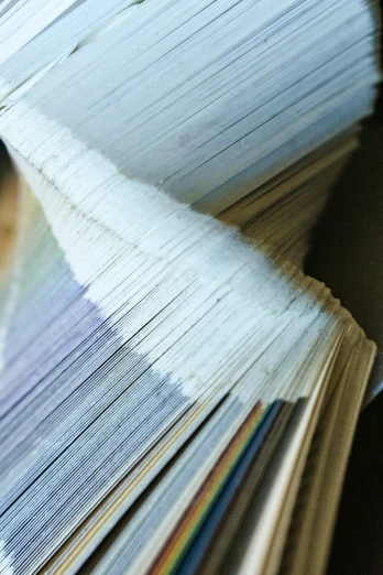 a stack of papers with white sheets in the middle