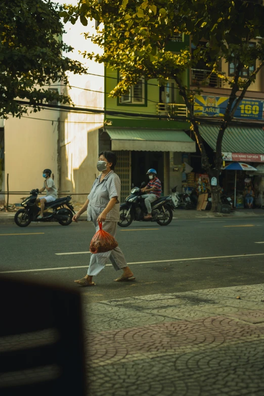 a man in a hat and dress on a city street