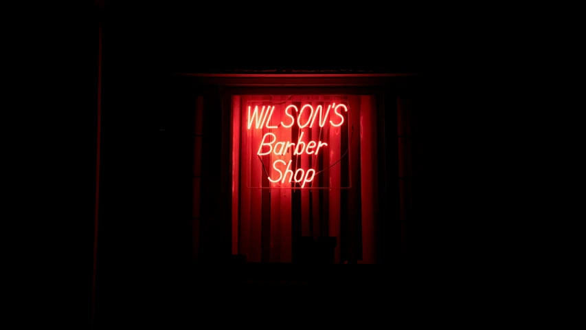 a red neon sign that says we serve butcher shop