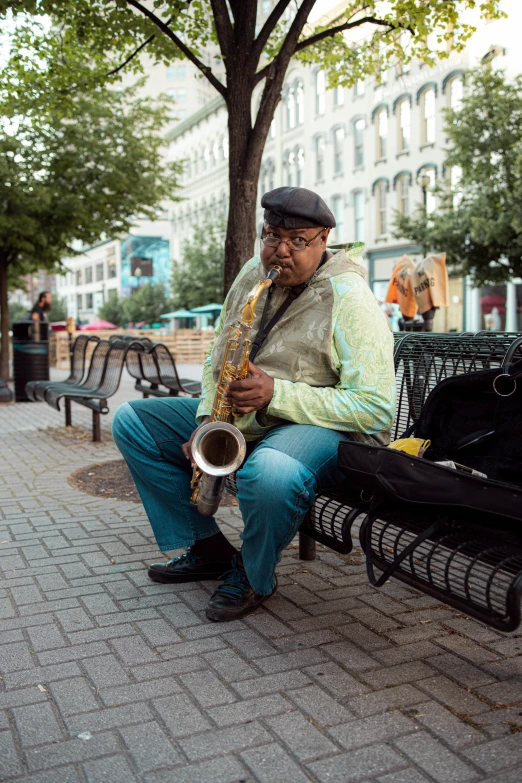 a person sitting on a bench with a saxophone