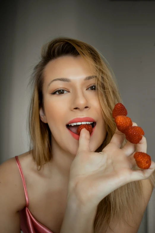 a woman eating oranges on her finger