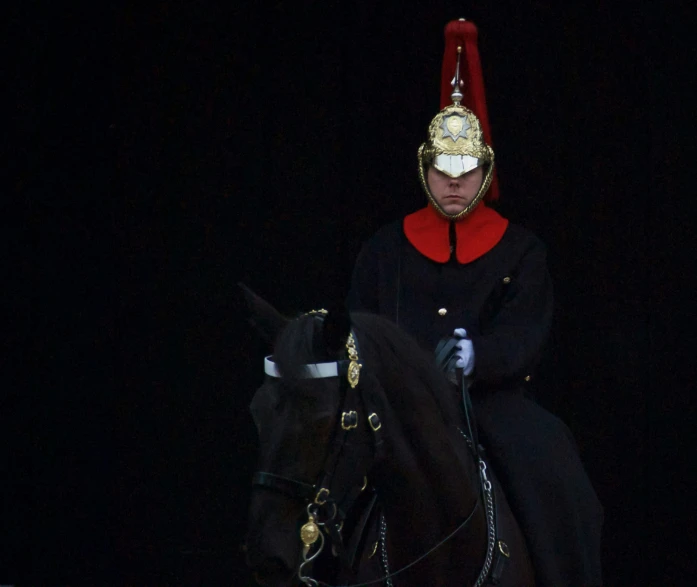 man in black costume on horse in dark area