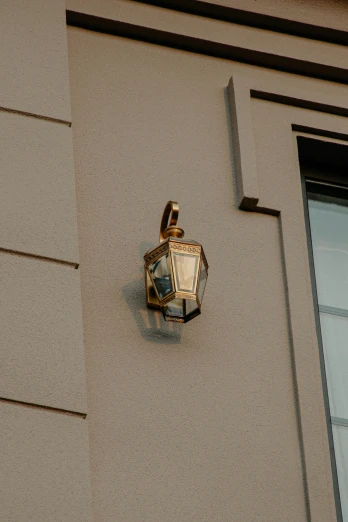 an old fashioned light is mounted to the side of a house