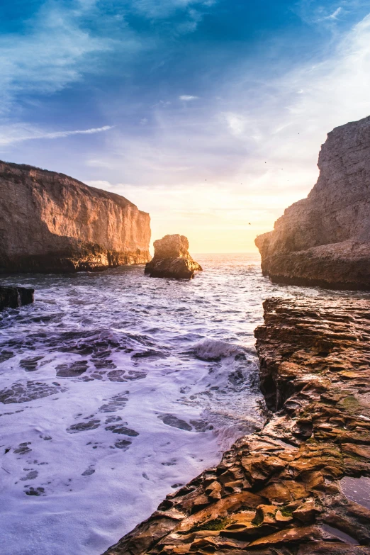 the water at a rocky beach by rocks