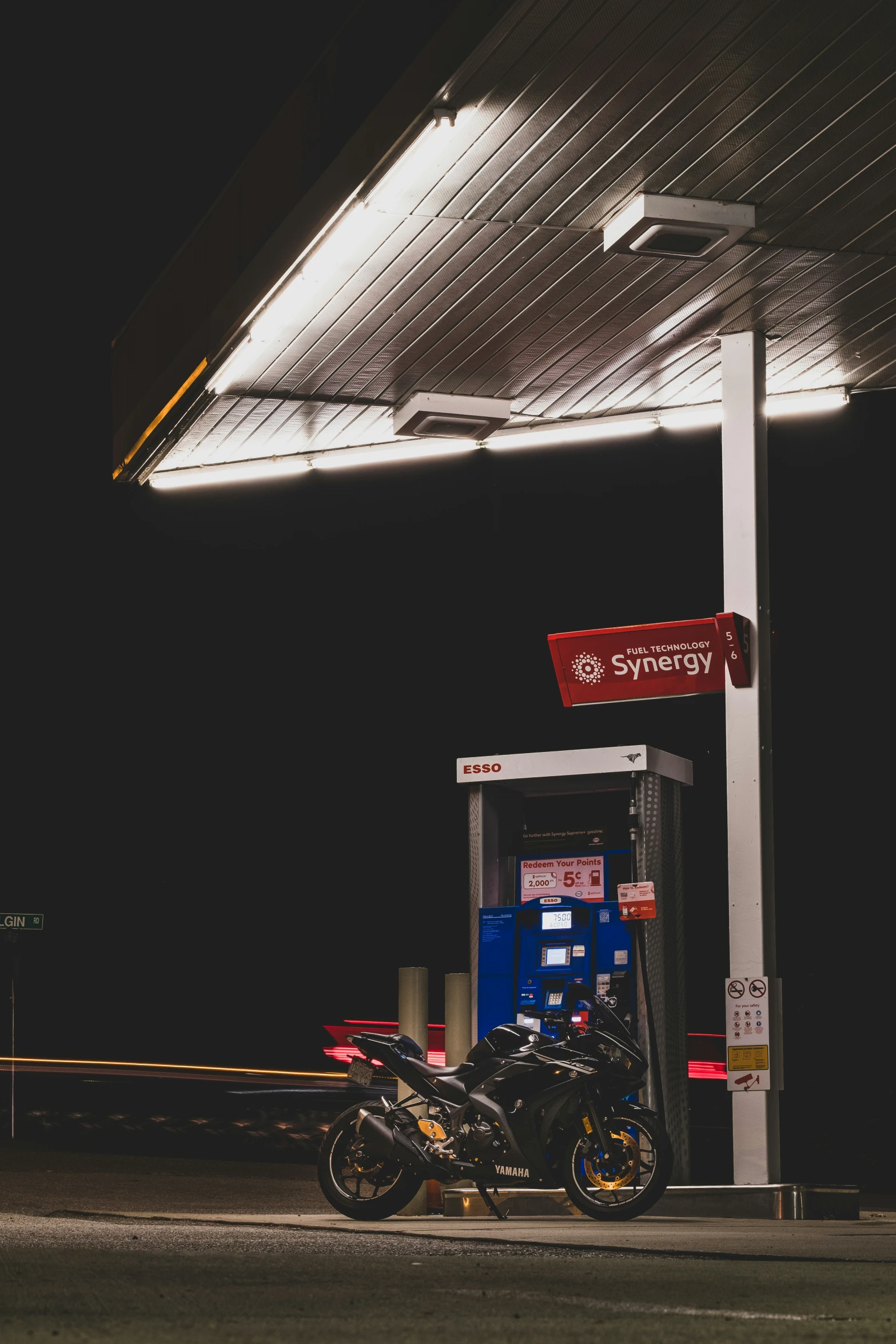 motorcycles at an energy fuel station at night
