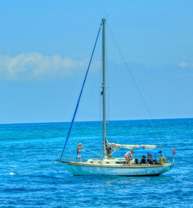 a sailboat is floating on the blue water