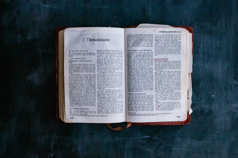 an old book is sitting on a table