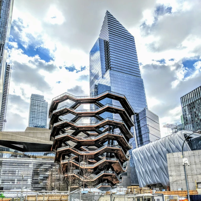 an art piece in the foreground of large city buildings