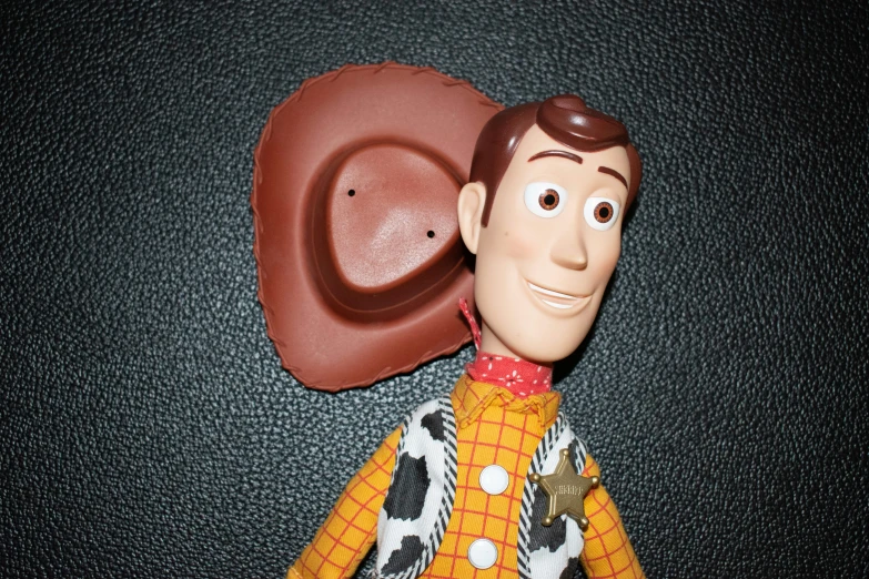 the toy figurine is wearing a cowboy outfit
