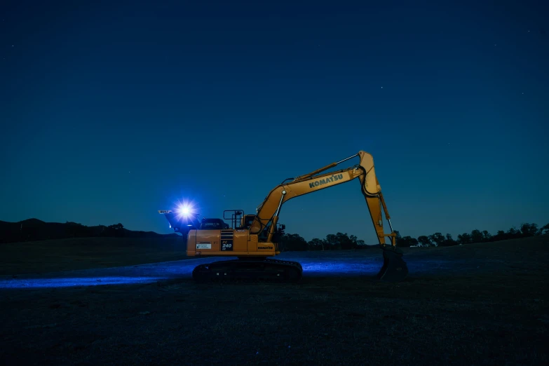 a tractor that is on the ground under some lights