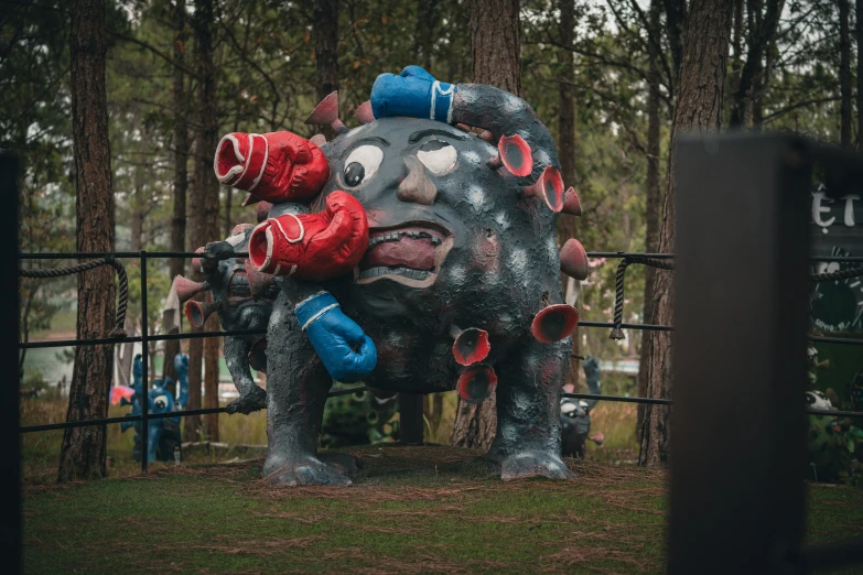 an elephant sculpture with red and blue water bottles on its back