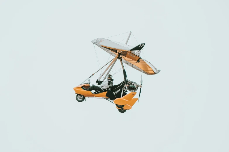 a man on a motorcycle being pulled by a glider