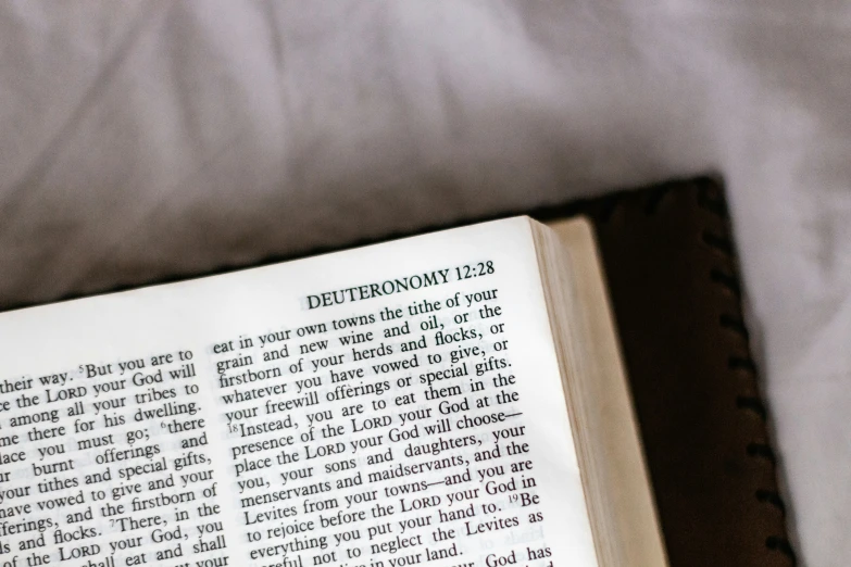 a black book that is open and sitting on a white cloth