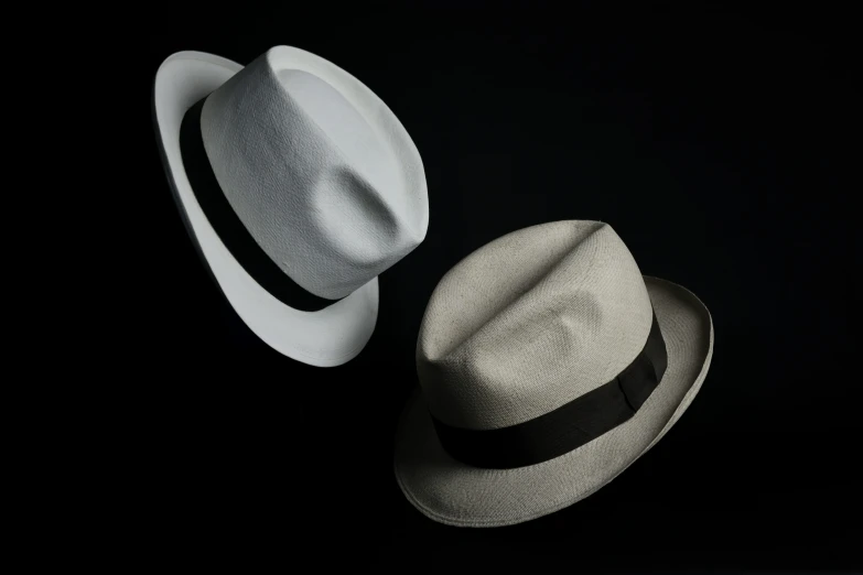 a white and a black hat are pictured