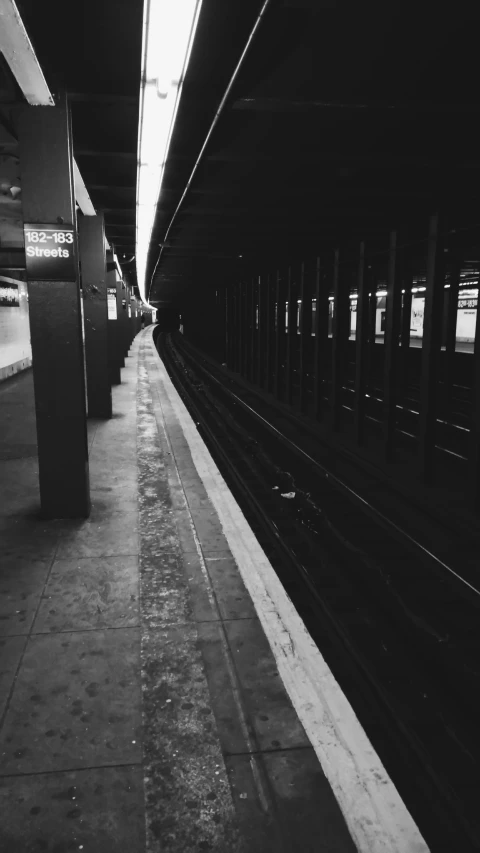 the black and white image shows a subway platform