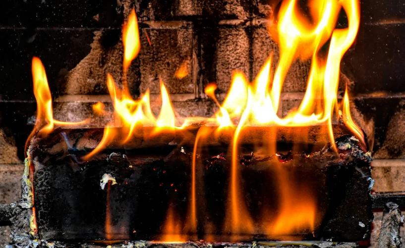 bright fire is glowing up from an old fireplace