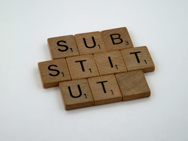scrabbles are arranged to spell out the word subtitute