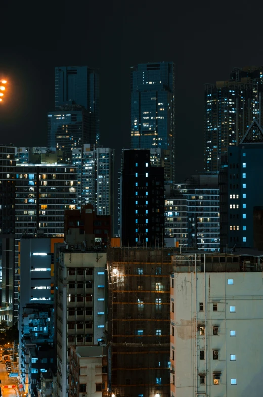 view of skyline at night from across the street