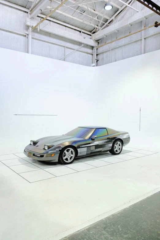 a car on a display in a white room